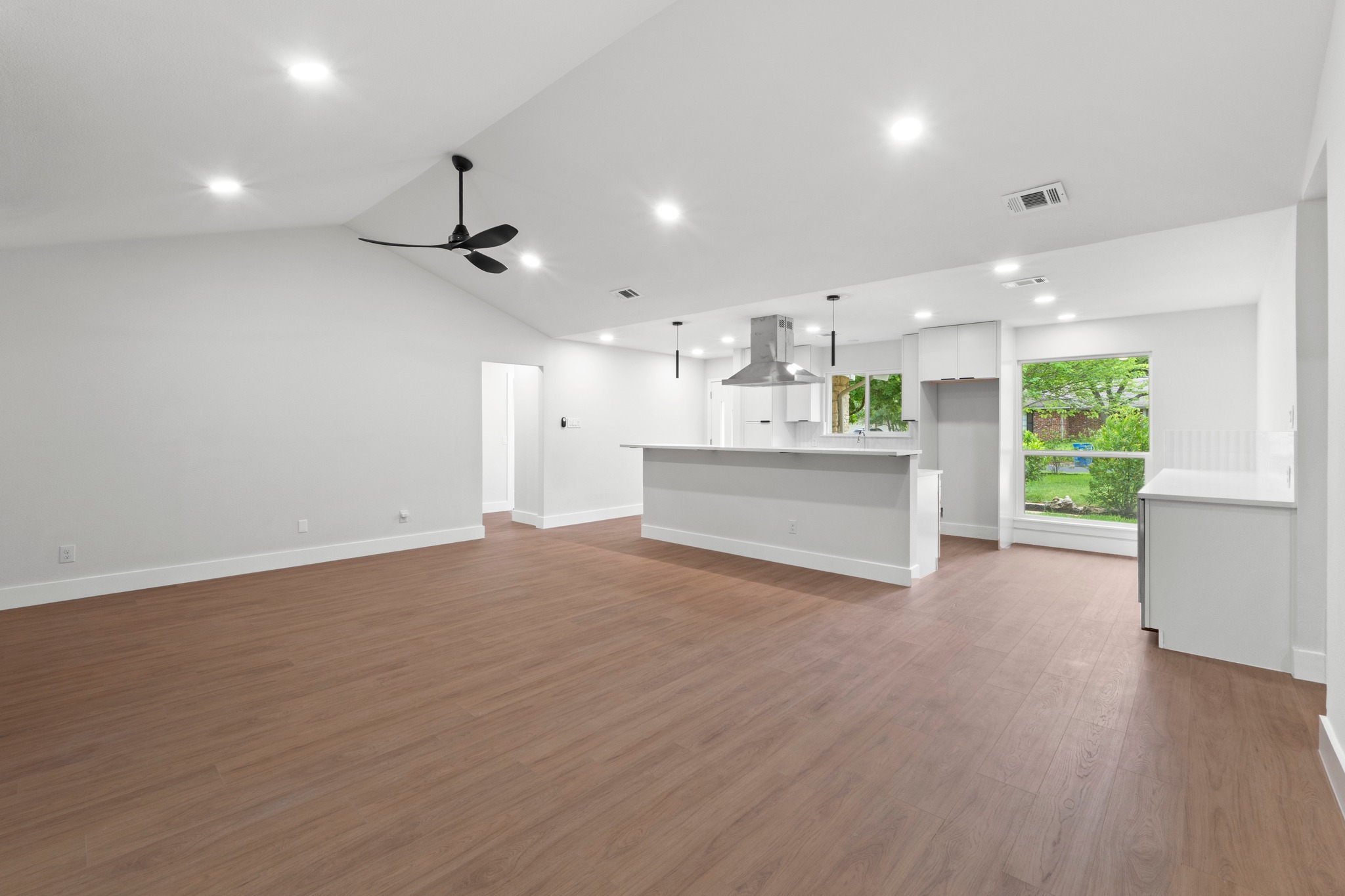 1608 Springer Lane Austin, TX 78758 - Photo 25 of 35 Spacious interior featuring wood-finish flooring, vaulted ceiling, and recessed lighting