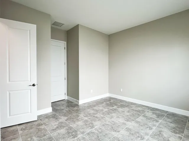 a bathroom with a granite countertop sink a toilet a mirror and bathtub