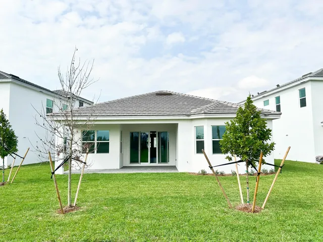 a view of a garden with a house in the background