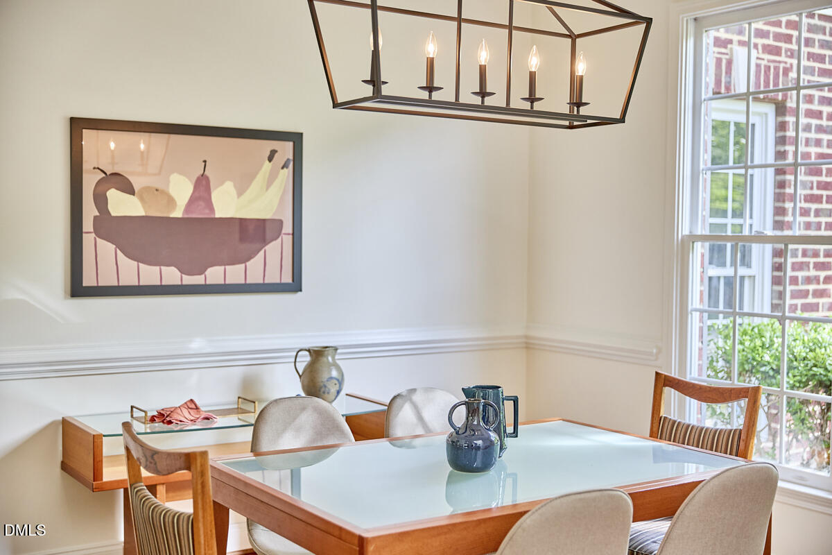 8030 Sundance Circle Durham, NC 27713 - Photo 11 of 61 a view of a dining room with furniture a potted plant and a window