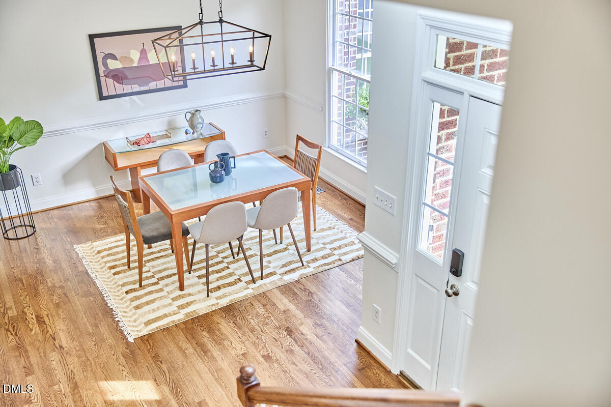 8030 Sundance Circle Durham, NC 27713 - Photo 13 of 61 a view of a dining room with furniture a chandelier and wooden floor