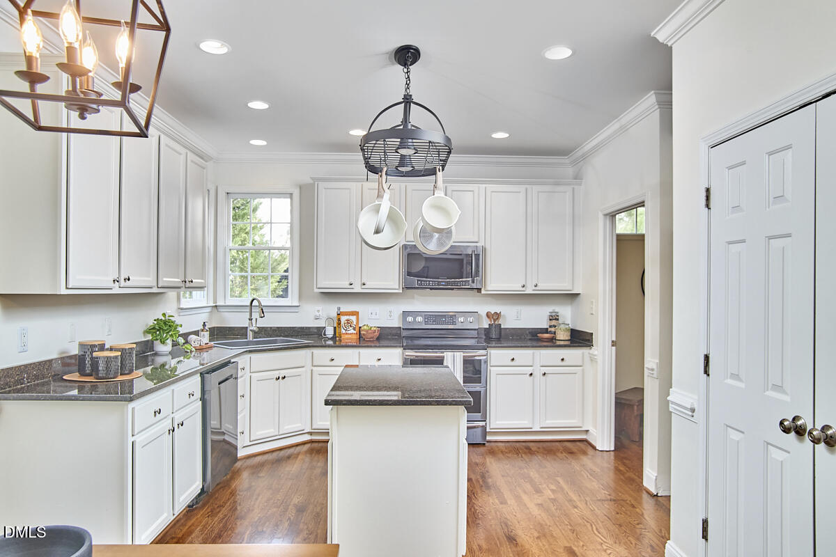 8030 Sundance Circle Durham, NC 27713 - Photo 28 of 61 a kitchen with a sink window and cabinets