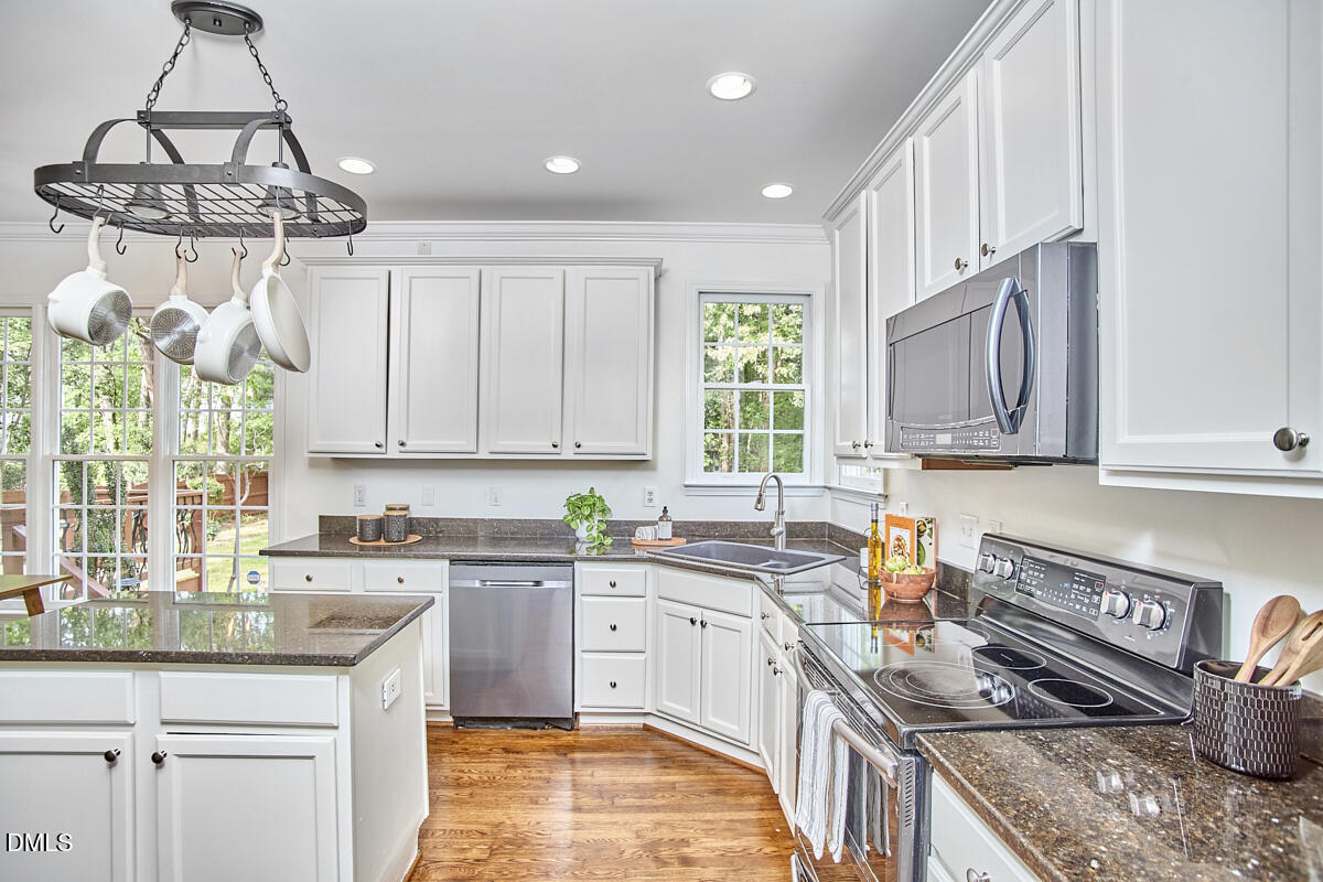 8030 Sundance Circle Durham, NC 27713 - Photo 31 of 61 a kitchen with a sink window and cabinets