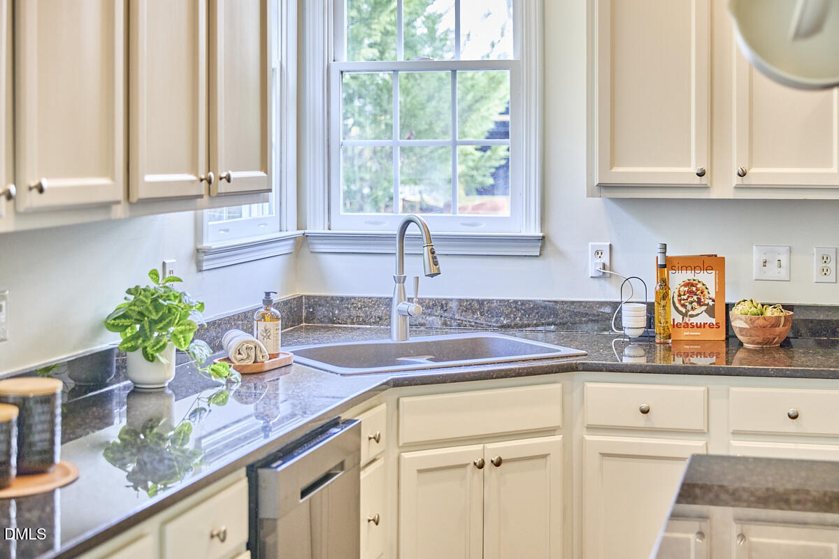 8030 Sundance Circle Durham, NC 27713 - Photo 32 of 61 a kitchen with granite countertop a sink a window and potted plant
