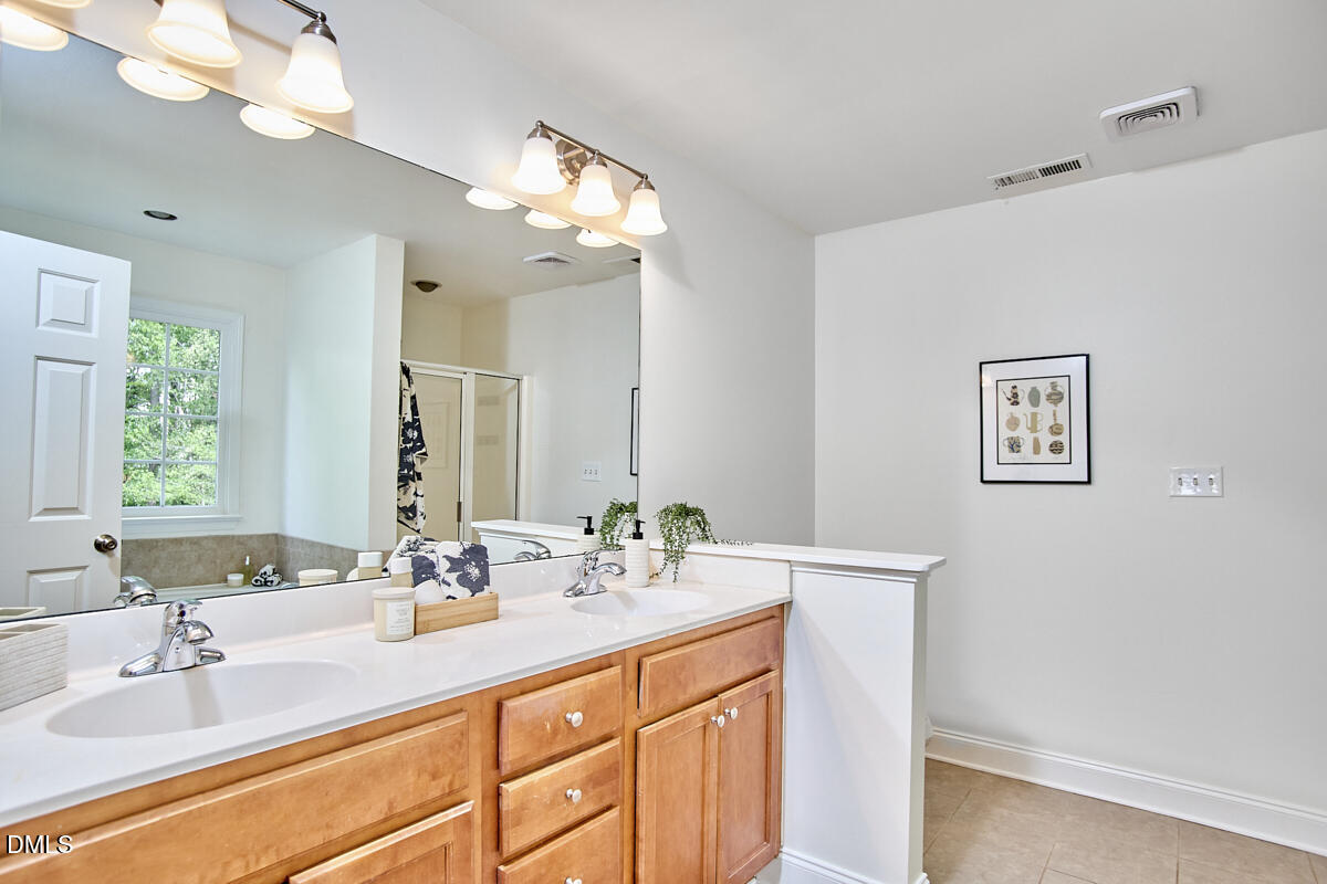 8030 Sundance Circle Durham, NC 27713 - Photo 41 of 61 a bathroom with a sink double vanity and a mirror