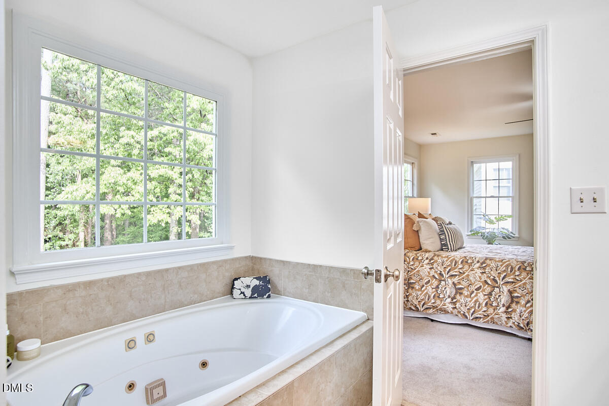8030 Sundance Circle Durham, NC 27713 - Photo 44 of 61 a bathroom with a tub sink and mirror