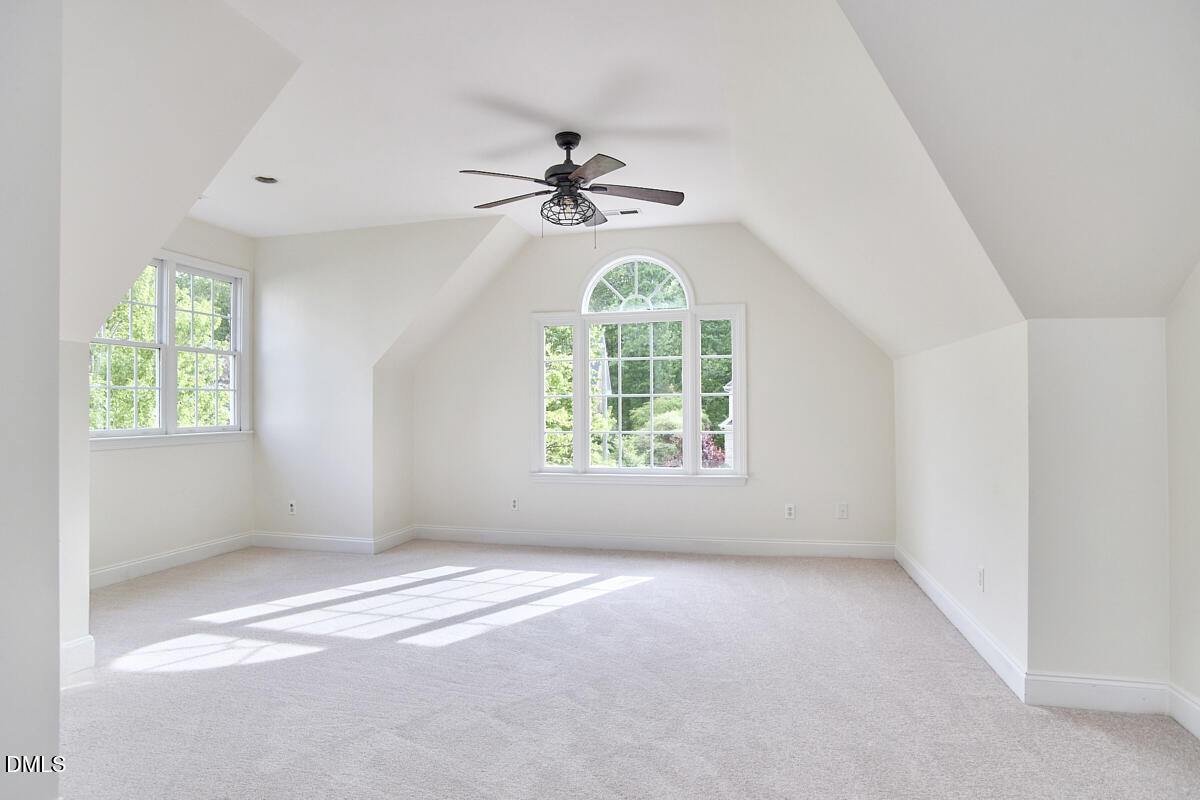 8030 Sundance Circle Durham, NC 27713 - Photo 45 of 61 an empty room with windows and chandelier fan