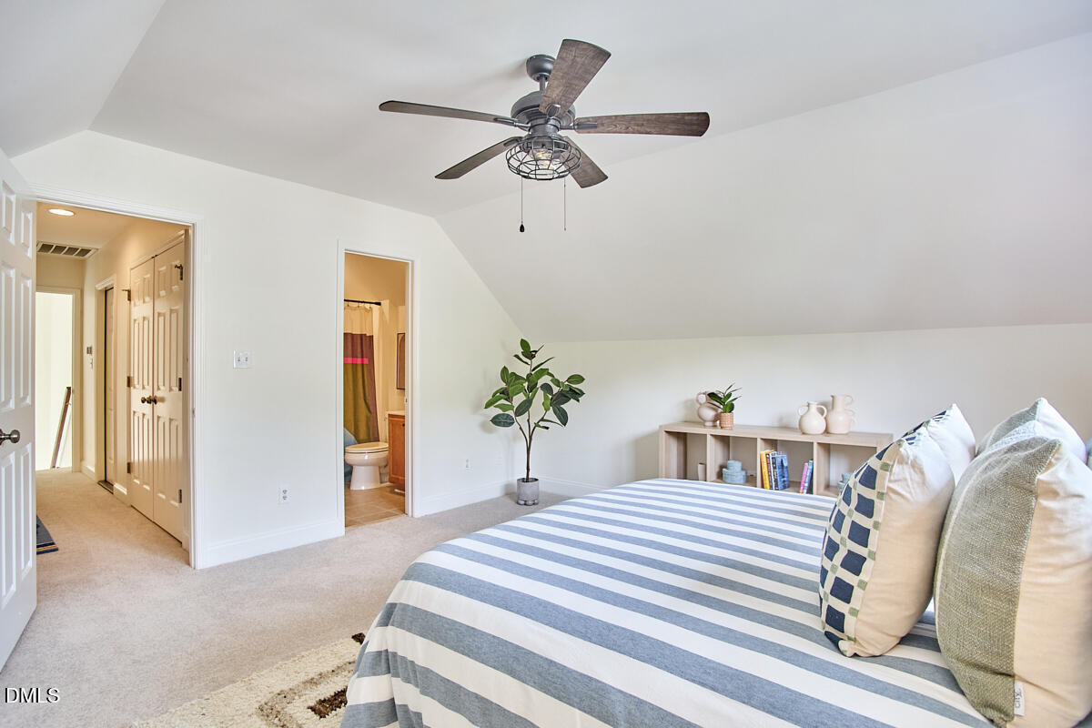 8030 Sundance Circle Durham, NC 27713 - Photo 49 of 61 a bedroom with a bed and a chandelier