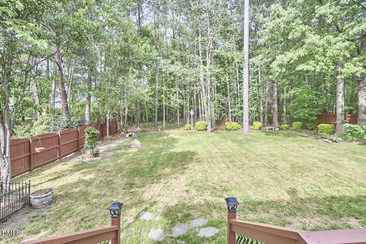8030 Sundance Circle Durham, NC 27713 - Photo 55 of 61 a backyard of a house with lots of green space and fountain