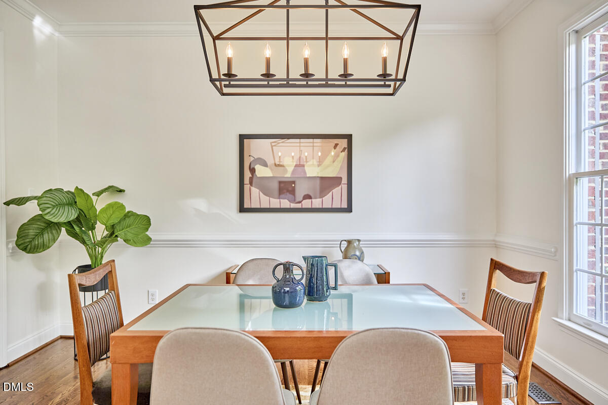 8030 Sundance Circle Durham, NC 27713 - Photo 10 of 61 a dining room with furniture a potted plant and a chandelier