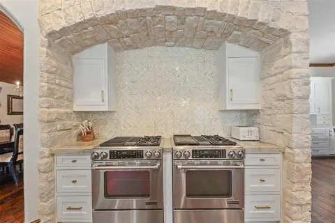 a stove top oven sitting inside of a kitchen