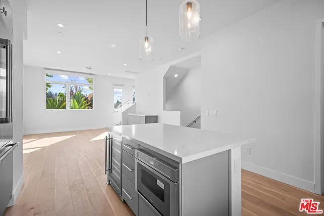 a kitchen with a sink and a stove top oven