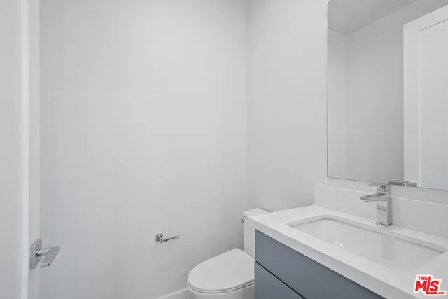 a bathroom with a sink toilet and vanity
