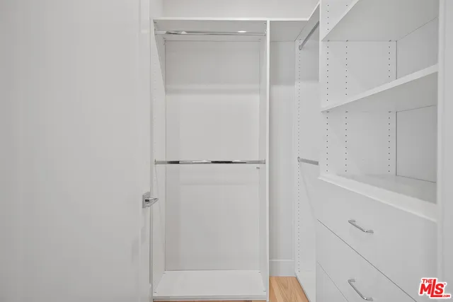 a bathroom with a tub sink vanity and shower