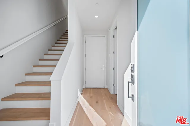 a view of entryway with wooden floor and stairs