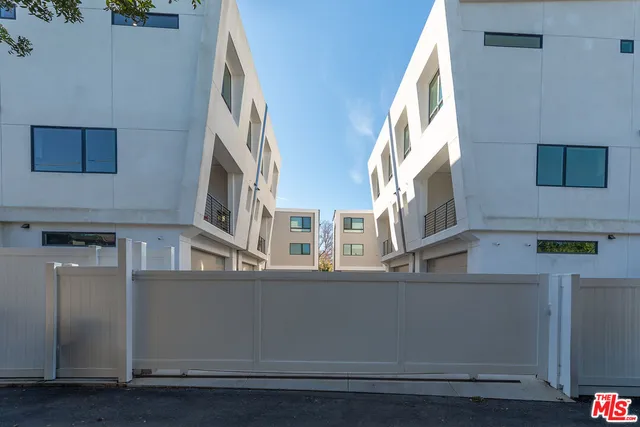 a view of a pathway of a house with a yard