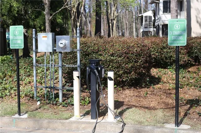 a street sign on a sidewalk next to a road