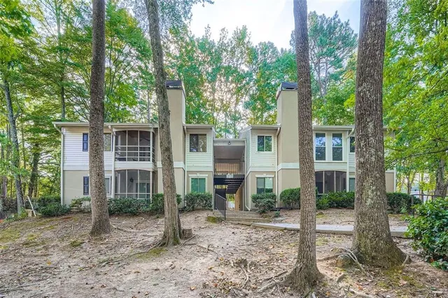 a view of a house with backyard view and a tree