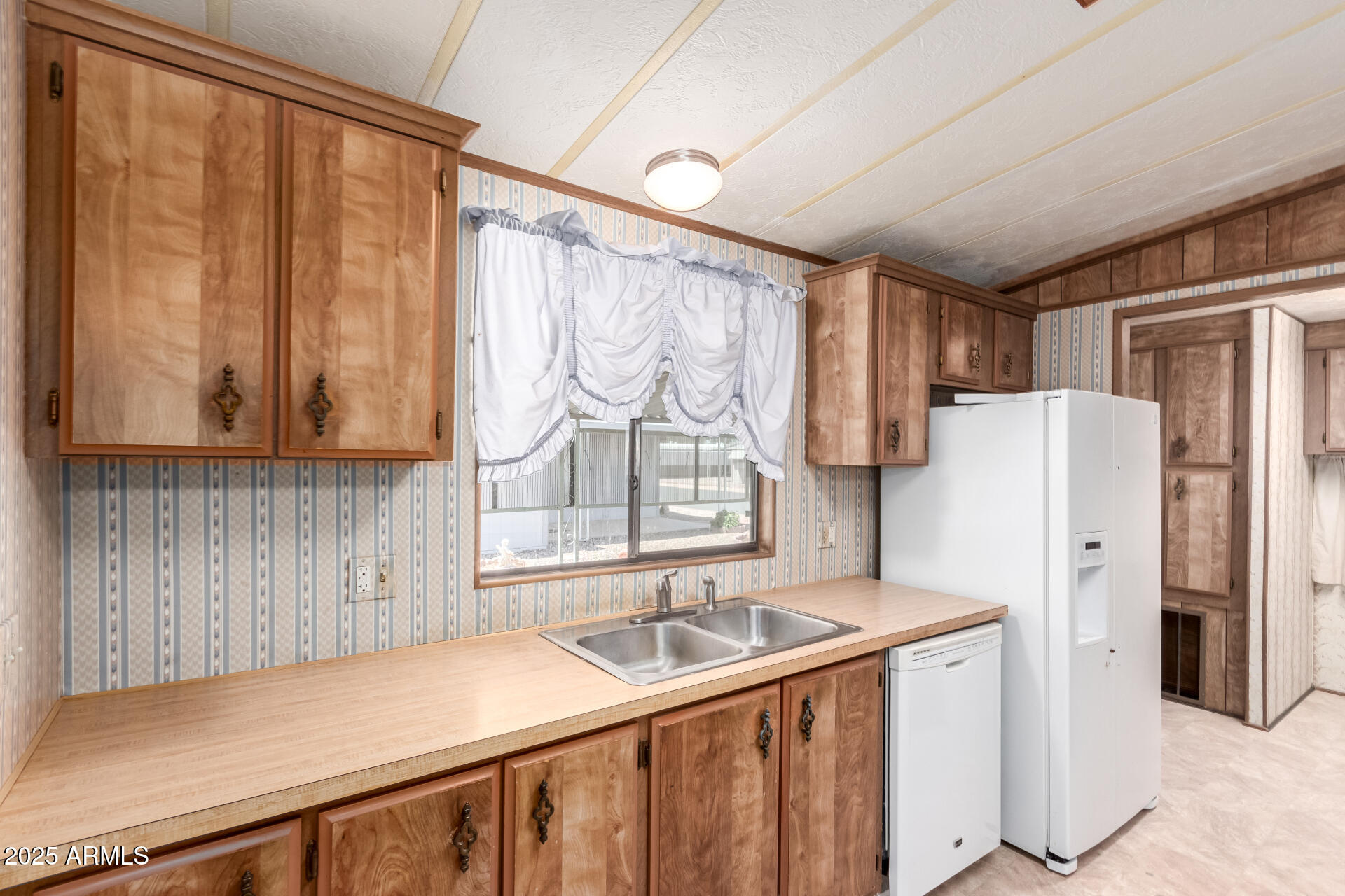 2100 North Trekell Road, Unit 229 Casa Grande, AZ 85122 - Photo 13 of 30 a kitchen with stainless steel appliances a refrigerator and a sink