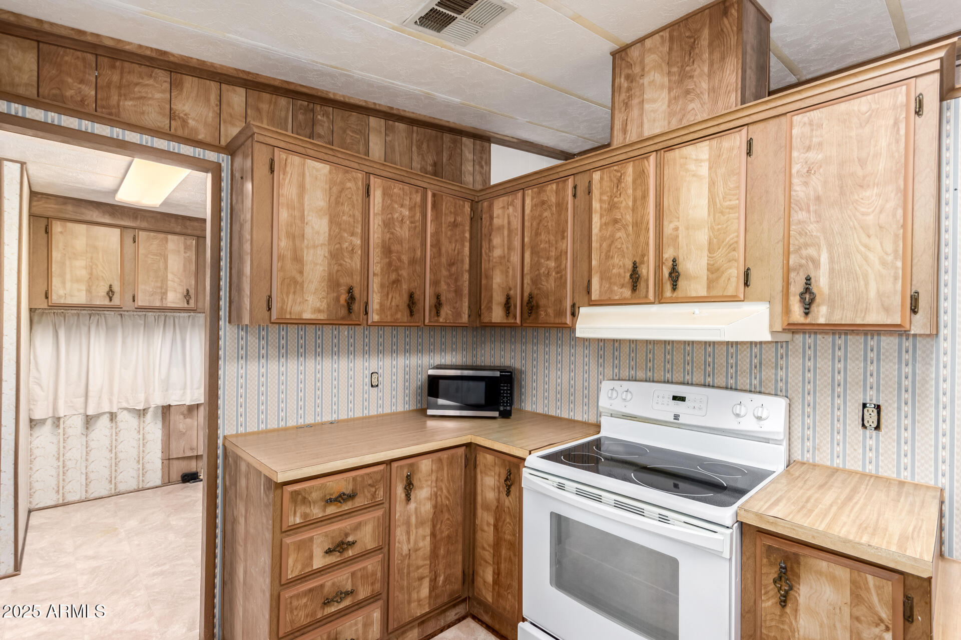2100 North Trekell Road, Unit 229 Casa Grande, AZ 85122 - Photo 14 of 30 a kitchen with a stove and a white cabinets