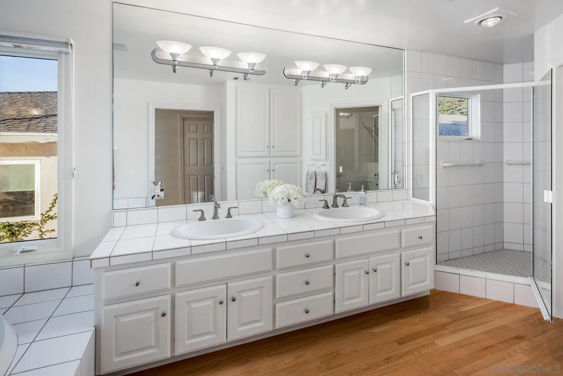 538 4th Street Encinitas, CA 92024 - Photo 21 of 35 a bathroom with double vanity sinks and a mirror