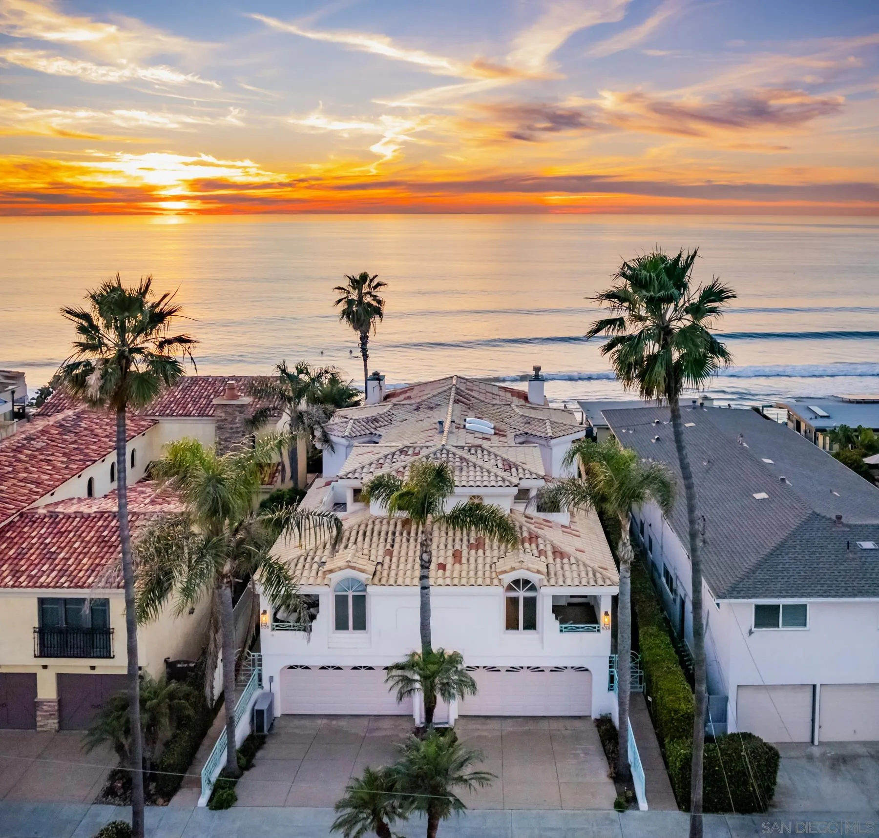 538 4th Street Encinitas, CA 92024 - Photo 3 of 35 a view of a white house with a palm tree next to a ocean