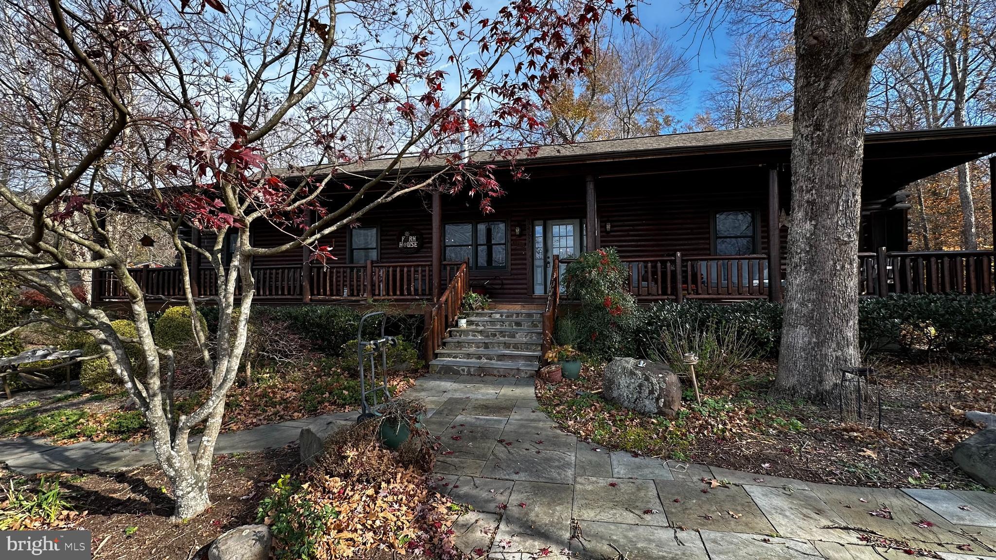 a view of a house with a tree in a yard