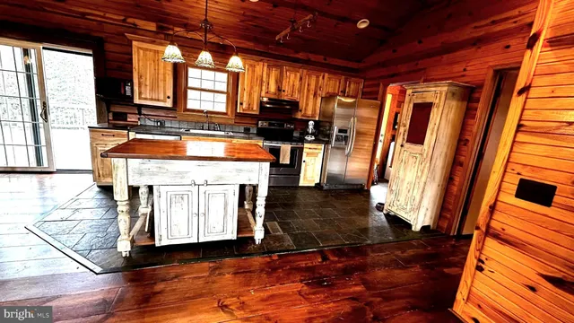a open kitchen with stainless steel appliances granite countertop a stove and a refrigerator