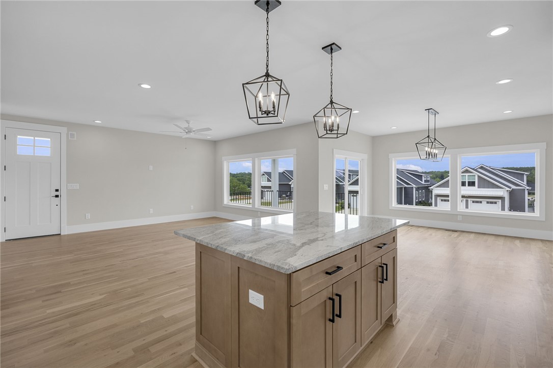 1230 Melton Road, Unit 216 West Union, SC 29696 - Photo 6 of 49 A well-lit interior space features sleek hardwood floors and a striking kitchen island, perfect for entertaining.