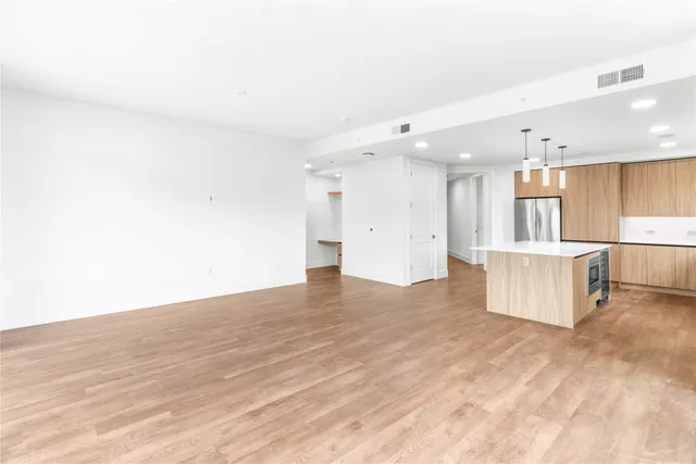 a view of kitchen with refrigerator and window