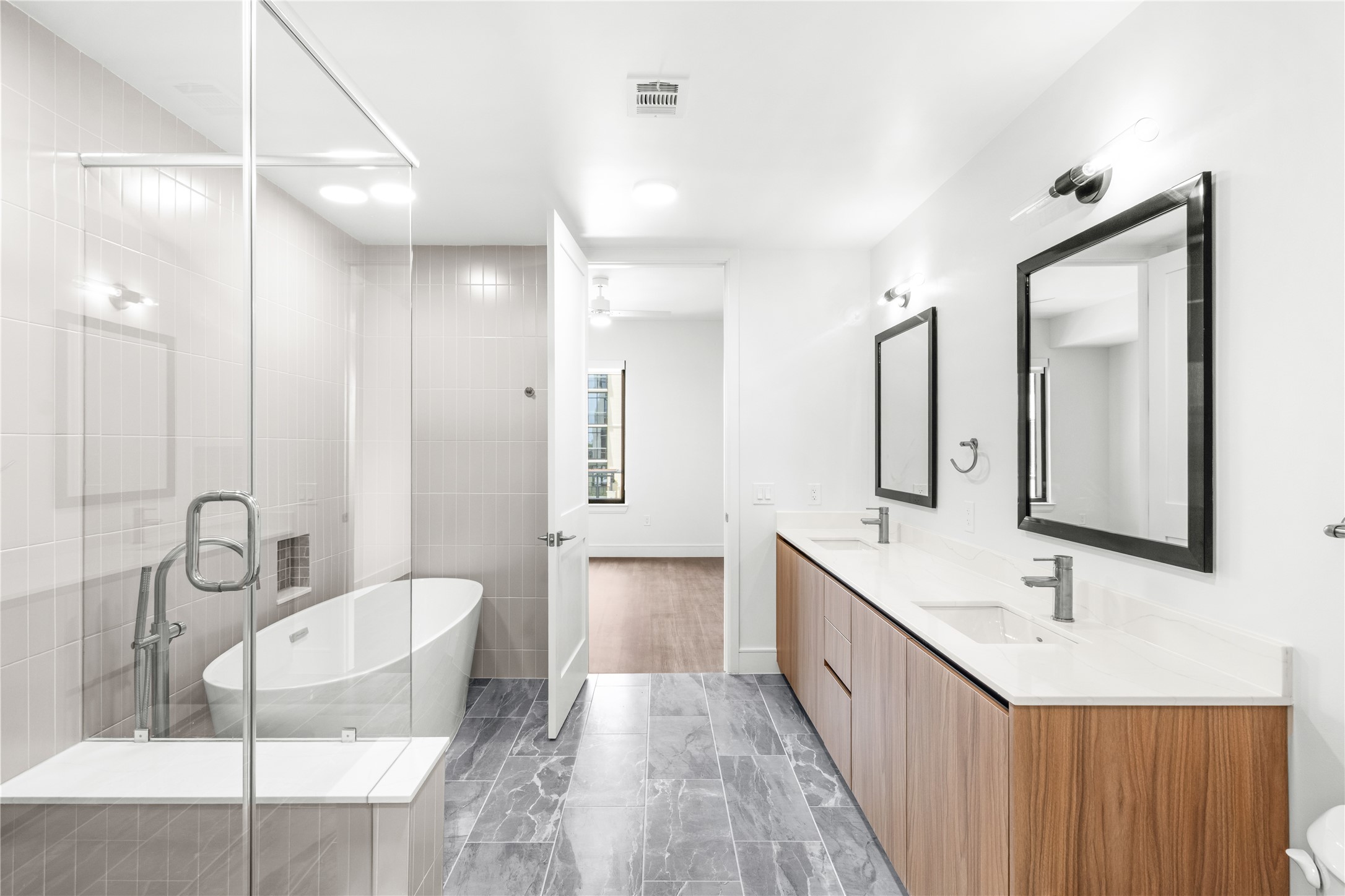 2311 Westheimer Road, Unit 529 Houston, TX 77098 - Photo 21 of 33 a bathroom with a double vanity sink mirror double and bathtub
