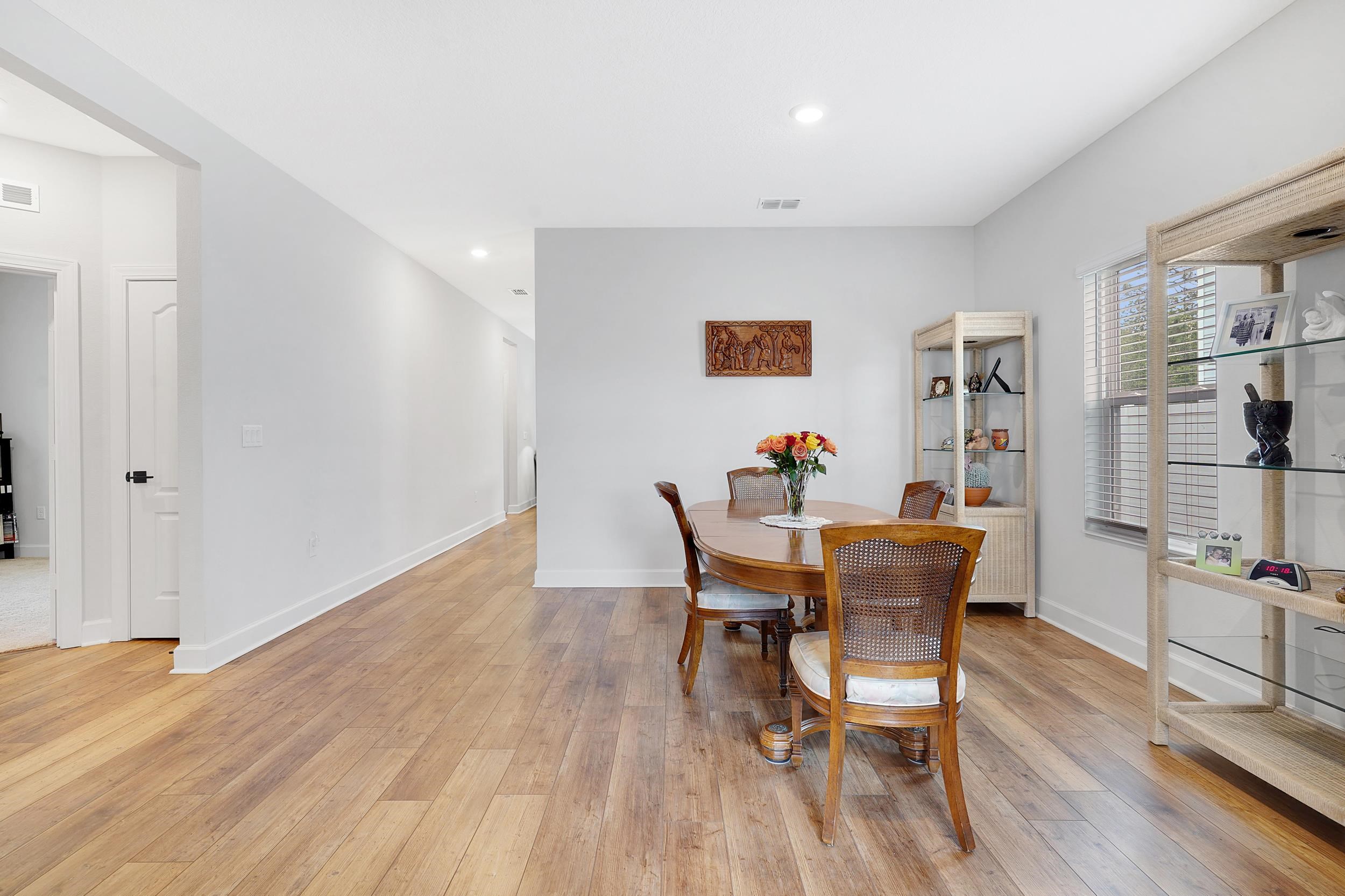 1014 Morgans Treasure Road St. Augustine, FL 32084 - Photo 5 of 31 a view of a dining room with furniture and wooden floor