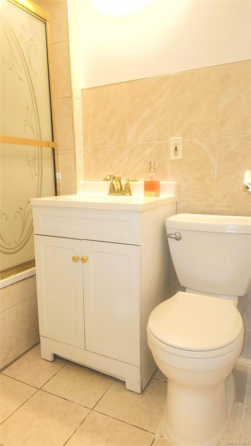 664 Remsen Avenue Brooklyn, NY 11236 - Photo 14 of 40 a white toilet sitting next to a sink
