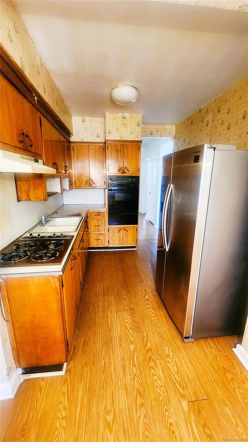 664 Remsen Avenue Brooklyn, NY 11236 - Photo 29 of 40 a kitchen with stainless steel appliances granite countertop a sink and a stove
