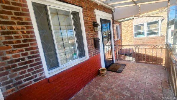 a view of a brick house with many windows