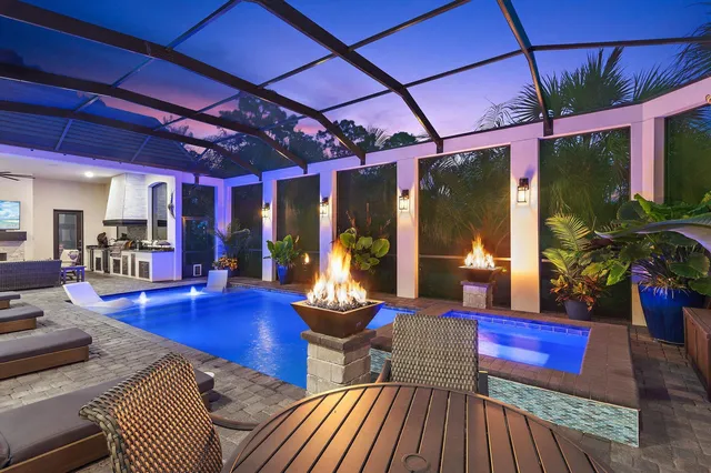 a living room with furniture a wooden floor and next to a large window