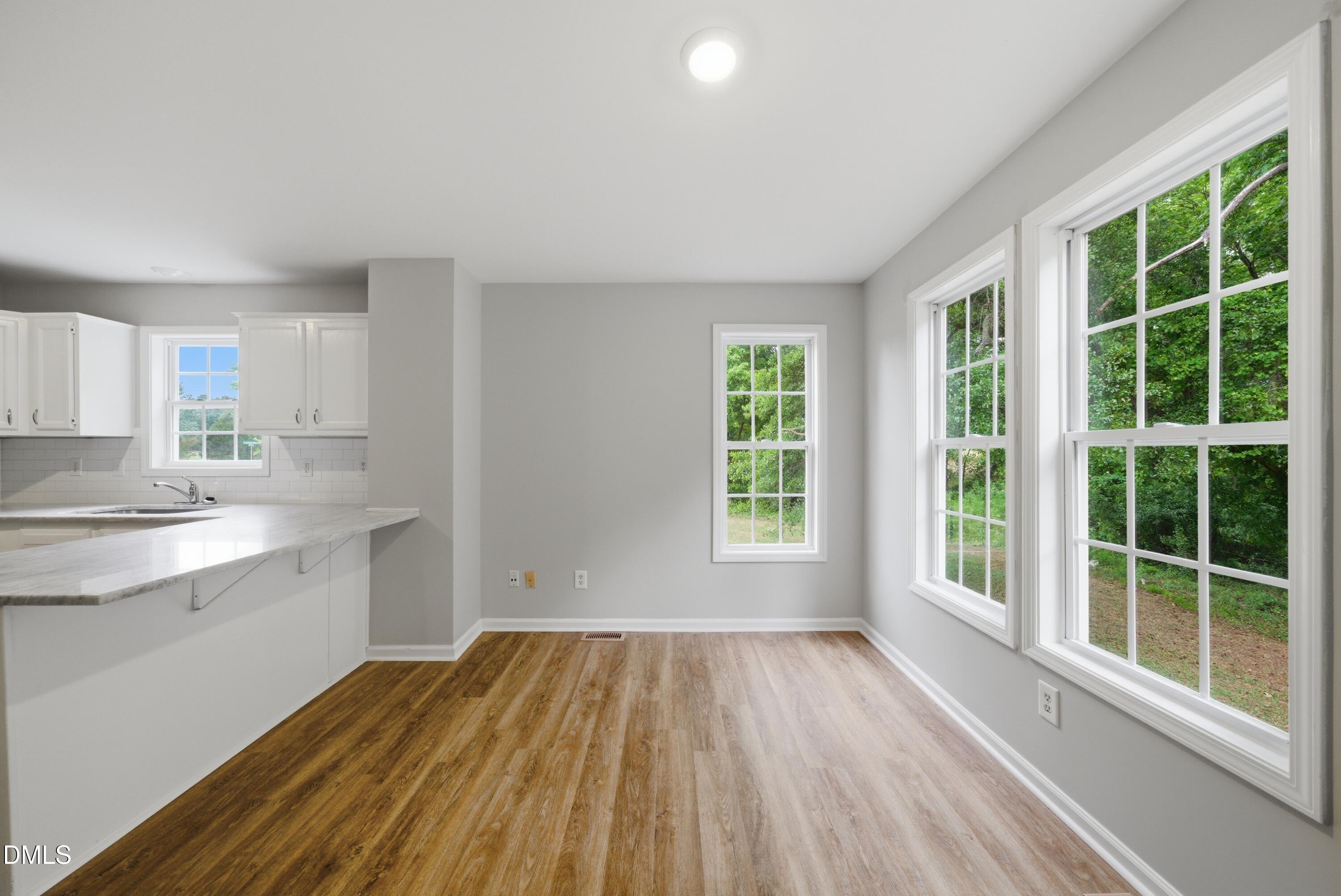 201 Tonylee Court, Unit A Raleigh, NC 27603 - Photo 16 of 30 a view of a kitchen with wooden floor and a window