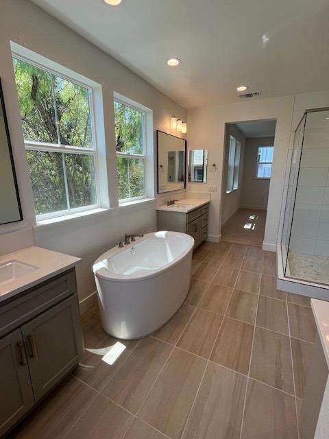 157 Haven Circle Pleasant Hill, CA 94523 - Photo 5 of 7 a bathroom with a bathtub a mirror a sink a window and a shower