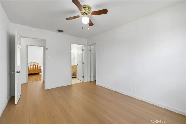 a view of a livingroom with a hardwood floor and a ceiling fan