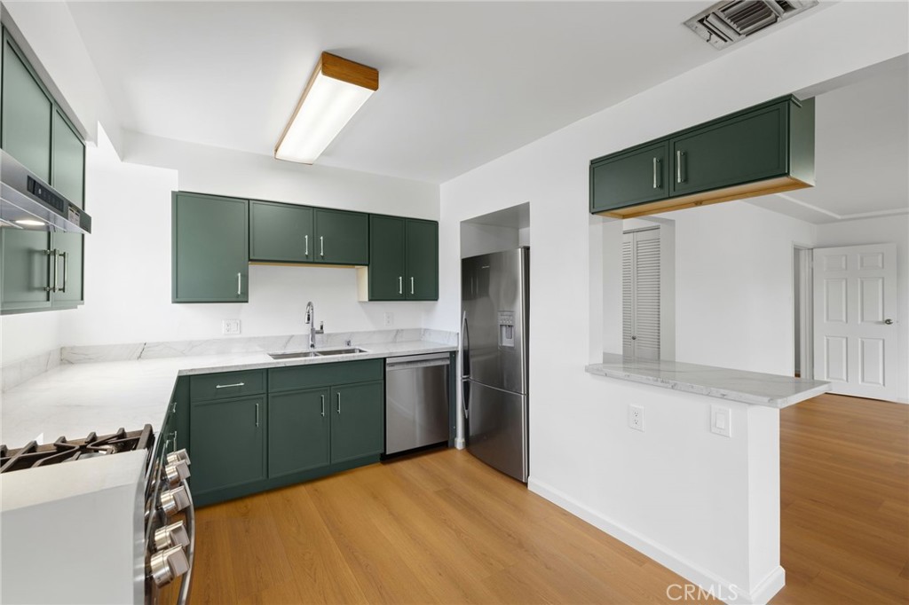 2407 North Keystone Street Burbank, CA 91504 - Photo 4 of 28 a kitchen with stainless steel appliances granite countertop a sink stove and refrigerator