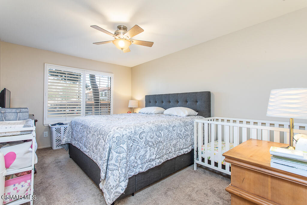 1772 Sinaloa Road, Unit 192 Simi Valley, CA 93065 - Photo 11 of 21 a bedroom with a bed and a chandelier