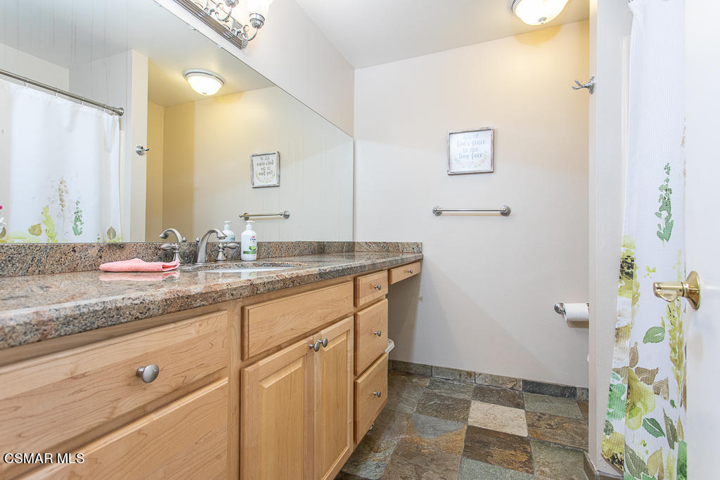 1772 Sinaloa Road, Unit 192 Simi Valley, CA 93065 - Photo 14 of 21 a bathroom with a granite countertop sink and a mirror