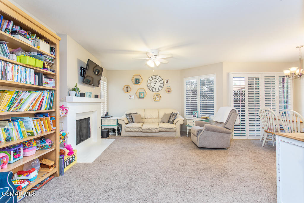 1772 Sinaloa Road, Unit 192 Simi Valley, CA 93065 - Photo 6 of 21 a living room with fireplace furniture and a book shelf