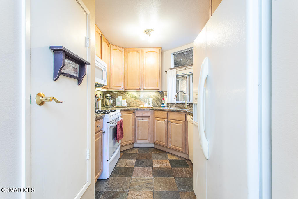 1772 Sinaloa Road, Unit 192 Simi Valley, CA 93065 - Photo 8 of 21 a kitchen with stainless steel appliances granite countertop a refrigerator and a stove top oven
