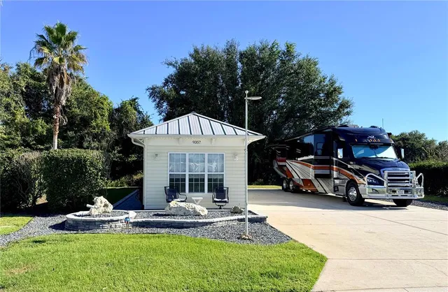 a view of a house with backyard porch and sitting area
