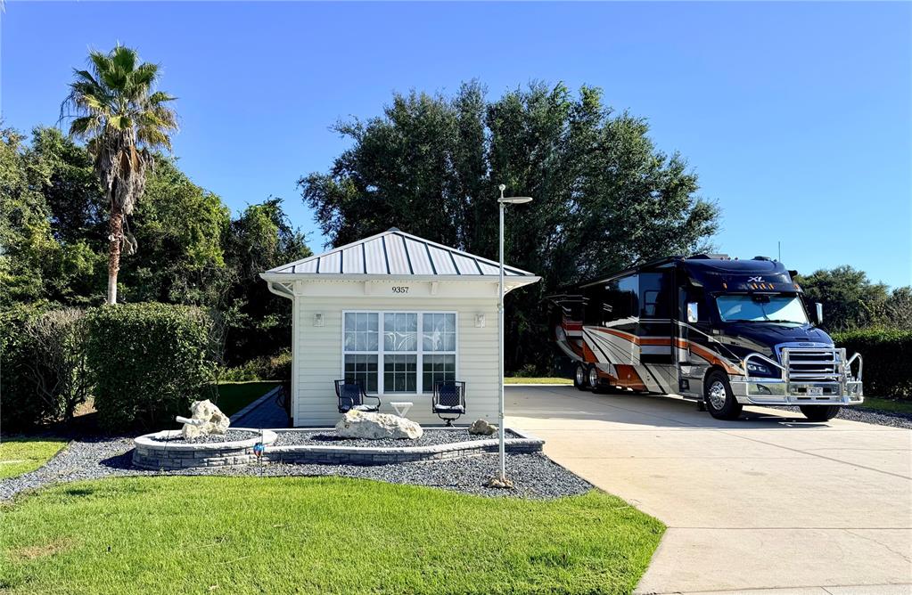 a view of a house with backyard porch and sitting area