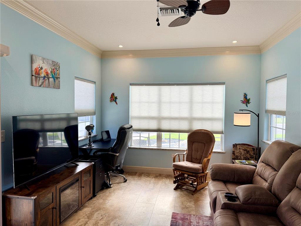 9357 Southeast 49th Terrace Webster, FL 33597 - Photo 16 of 39 a living room with furniture and a window