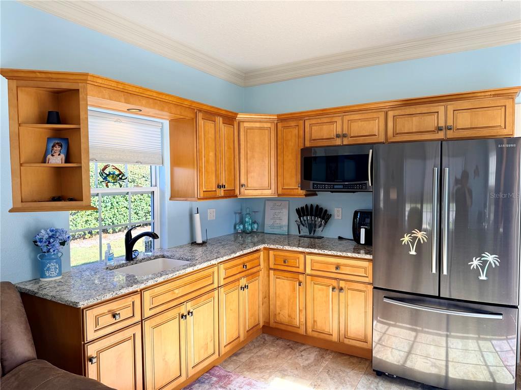 9357 Southeast 49th Terrace Webster, FL 33597 - Photo 18 of 39 a kitchen with stainless steel appliances granite countertop a sink and a cabinets