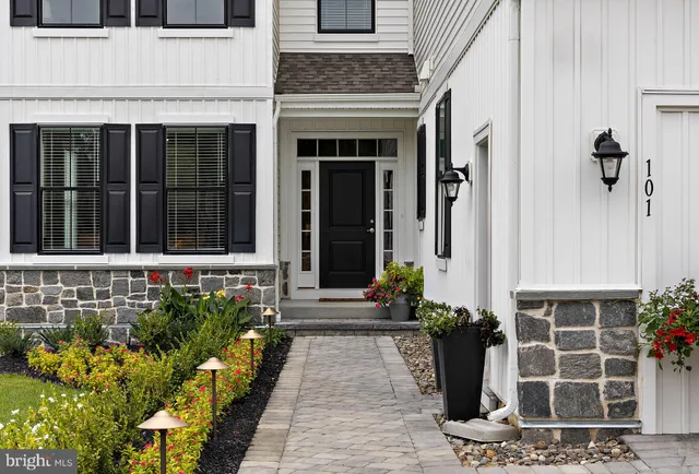 a front view of a house with a garden
