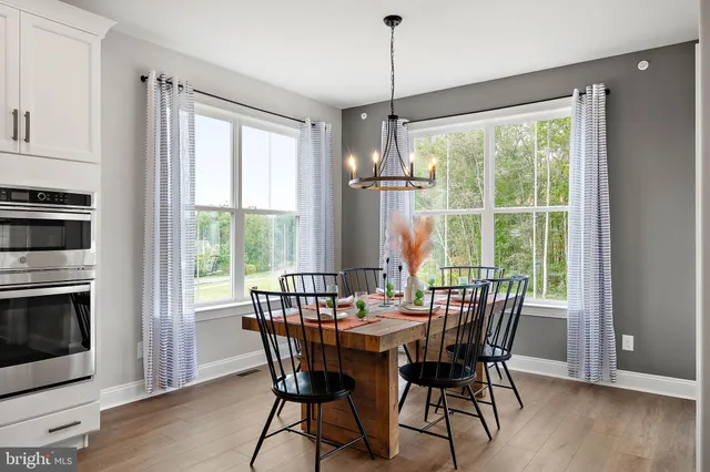 a view of a dining room with furniture window and wooden floor